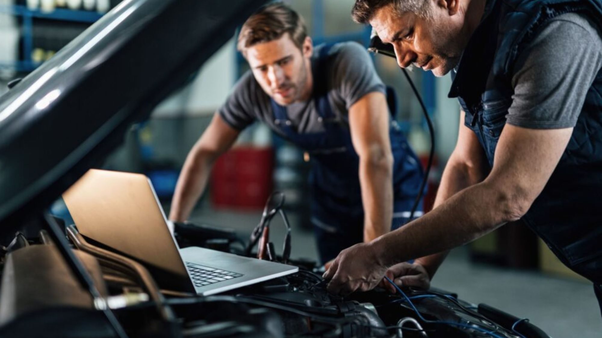 Two senior mechanic performing basic engine maintenance checks